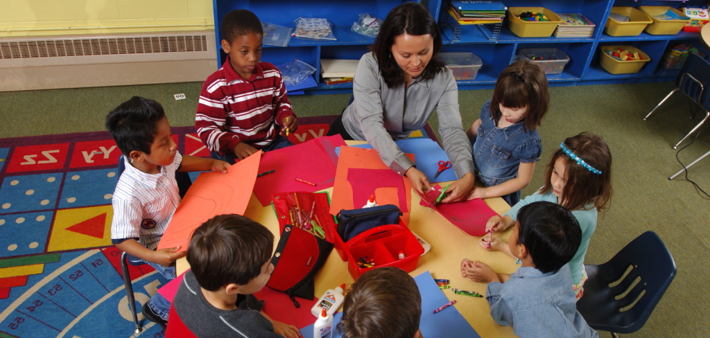 Kindergarten teacher working with students