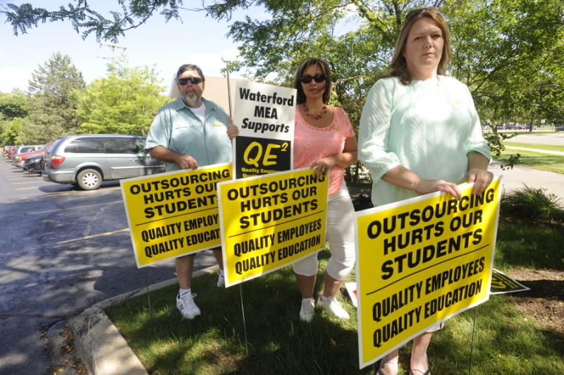 L-R: Drew Campbell, Teddie Watson, and Heather Madigan stand with signs used to gather support for their efforts.  The MEA and supporters were successful in thwarting an attempt to outsource almost 200 ESP jobs in Waterford, Mich.  Campbell and Madigan are both custodian engineers in the Waterford School District.  Watson is a bus driver in the WSD.  Photo taken on Tuesday, June 23, 2015, at the NEA local office in Bloomfield Hills, Mich.  (Jose Juarez/Special to the NEA)