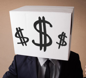 Businessman gesturing with a cardboard box on his head with dollar signs