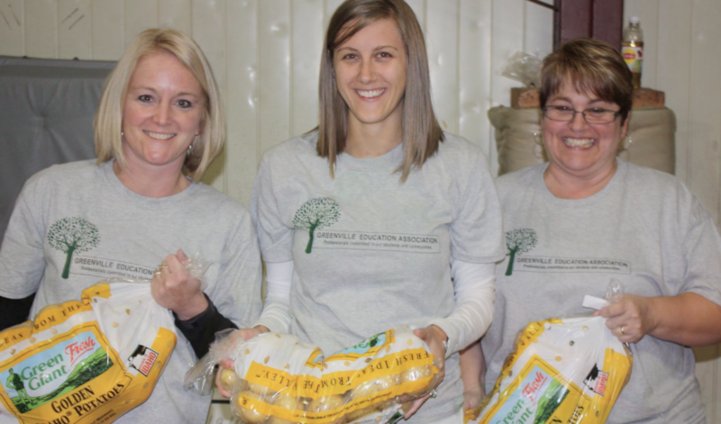 Volunteers from the Greenville Education Association gather donations for the Central Illinois Food Bank’s Mobile Pantry.