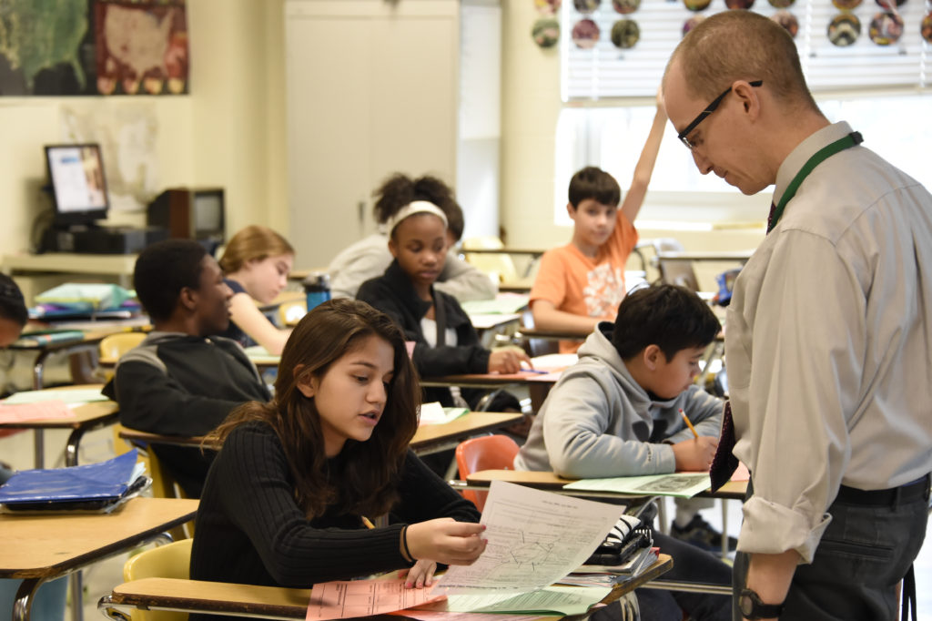 teacher with student in class