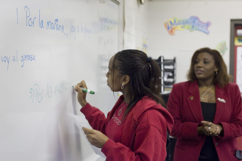 student and teacher at white board