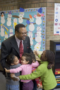 students hugging teacher