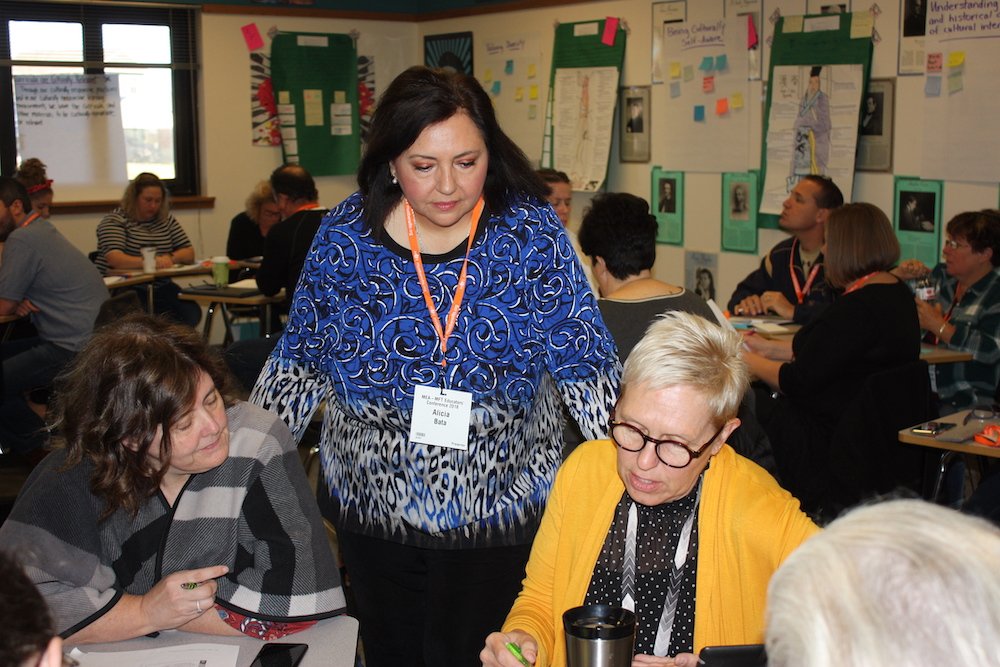 Alicia bata with teachers in classroom
