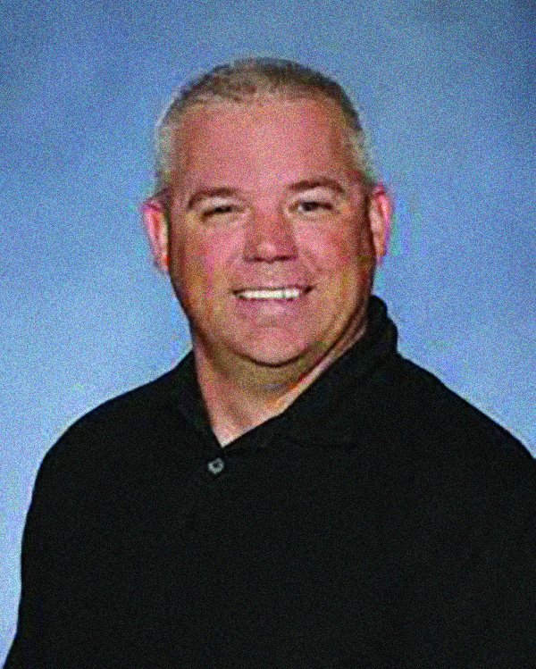 white man in black polo shirt looking directly into the camera