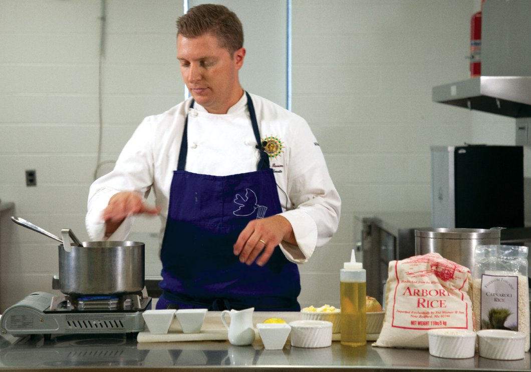 Culinary Arts Teacher Adam Monette cooking in the classroom kitchen