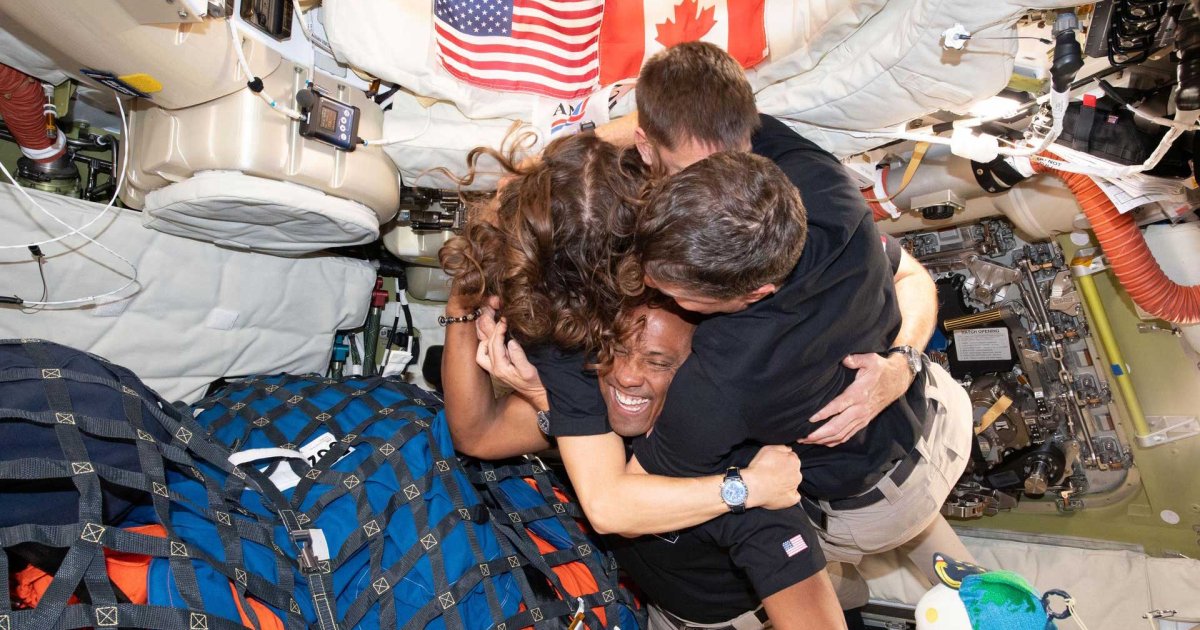 Artemis II crew members embracing — a bridge between ancient wisdom and space exploration