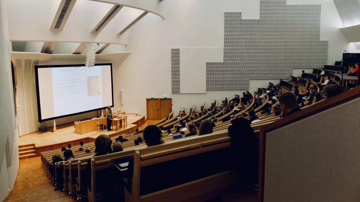 A professor teaches in a large lecture hall