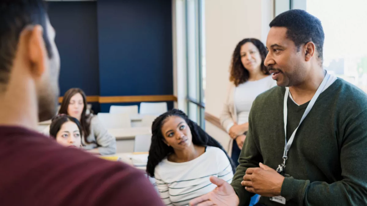 A male teacher talks about gun violence with high school students