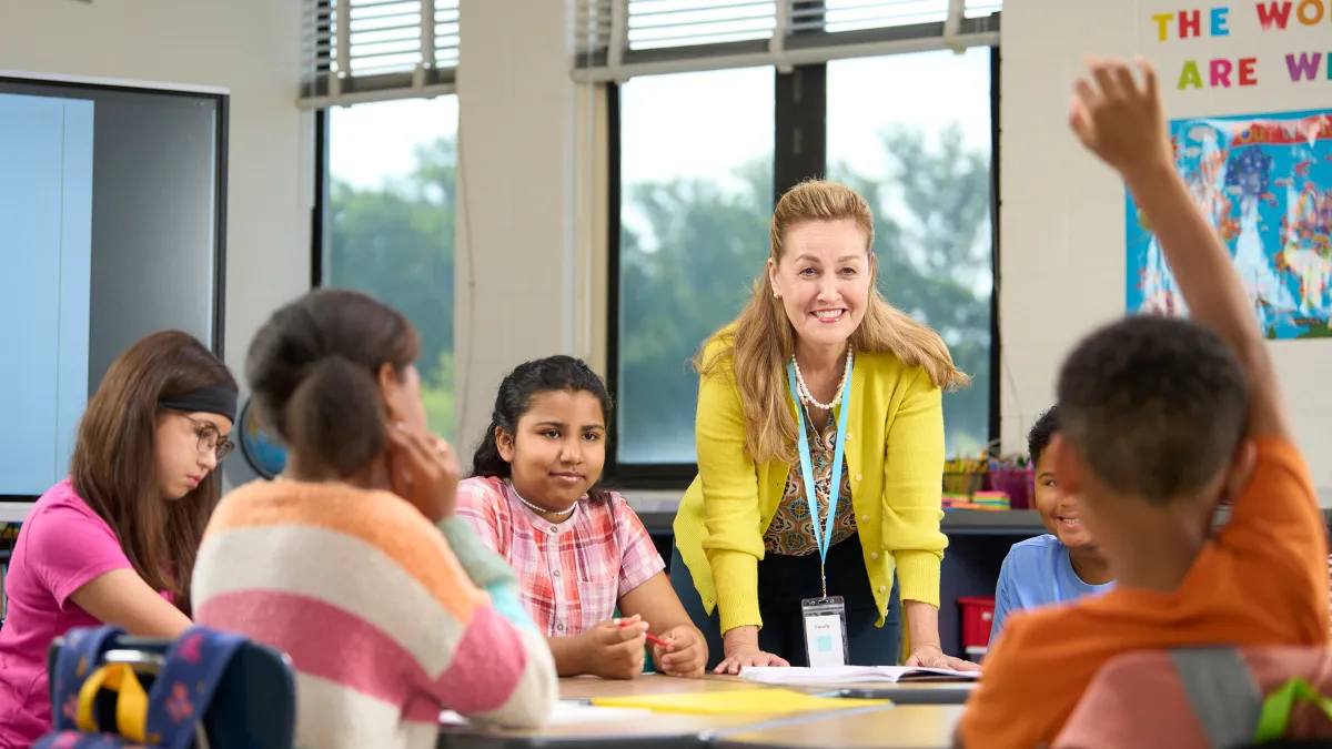 Students at table with teacher