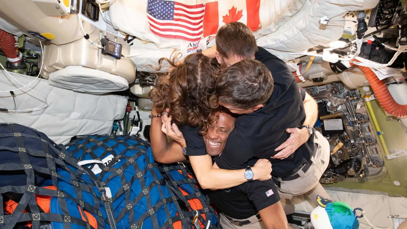 The crew of the Artemis II hugging inside the capsule.