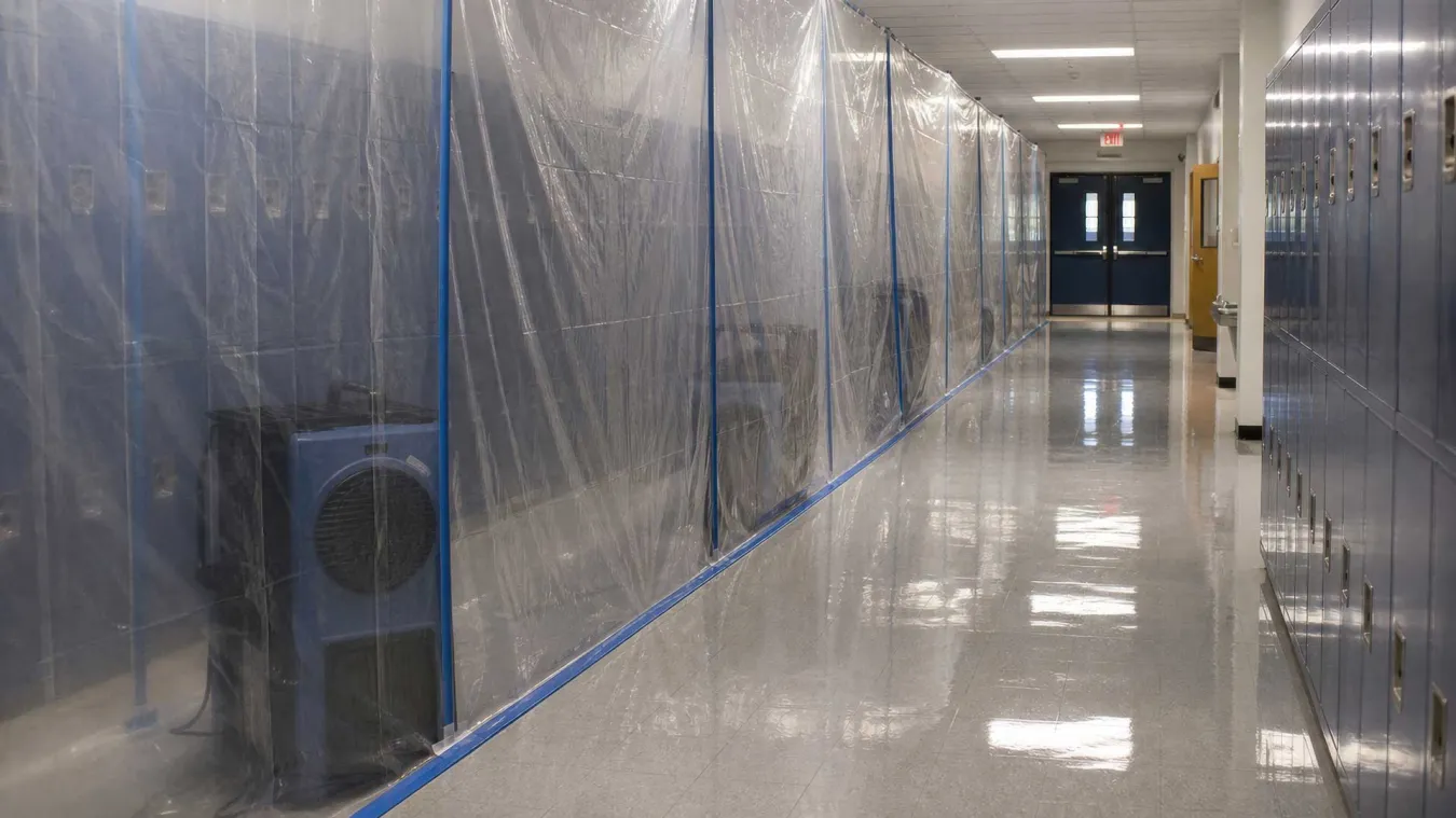 School corridor partitioned for mold treatment.