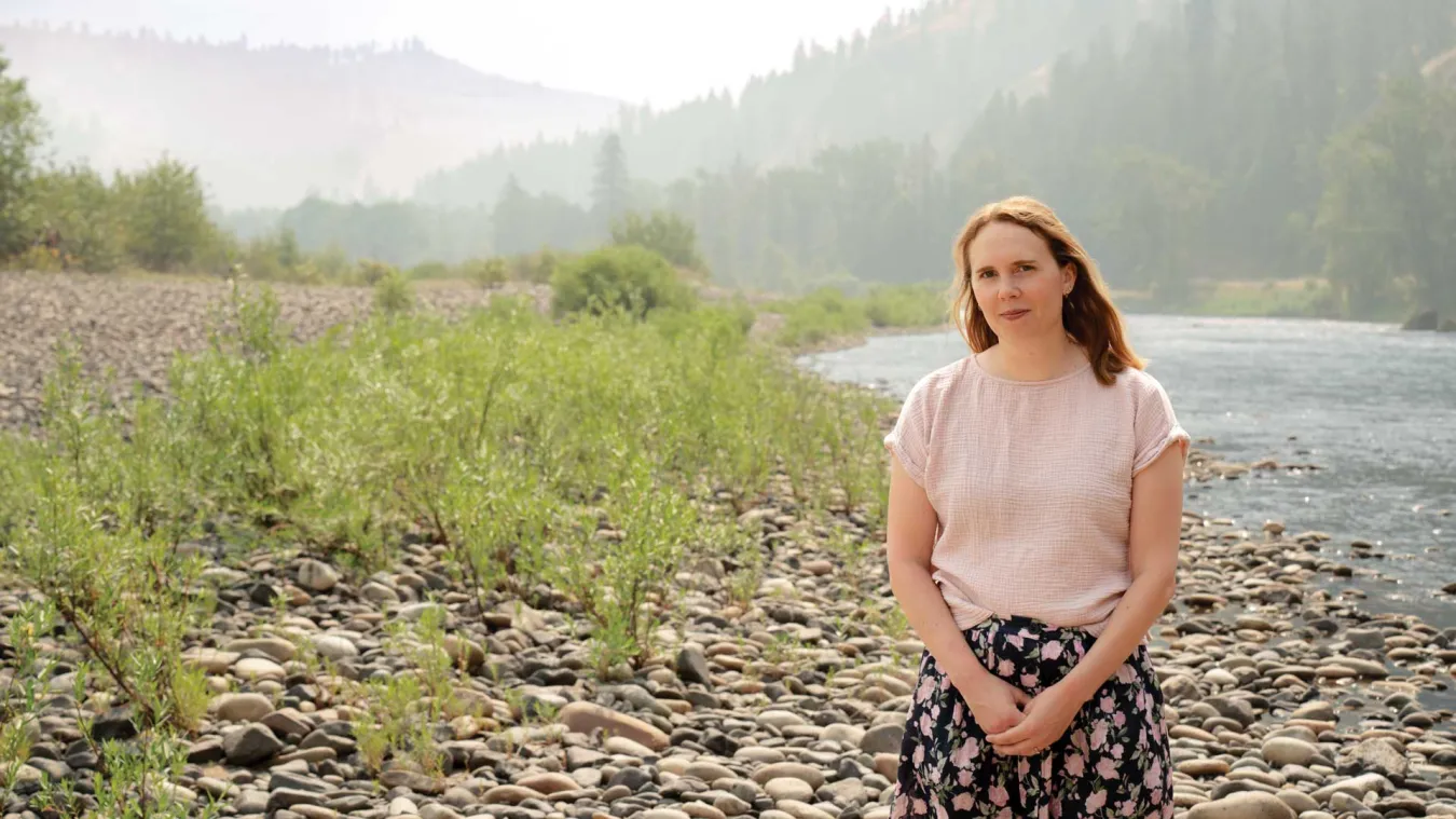 Idaho teacher Janna Privette standing on the shores of a mountain river.
