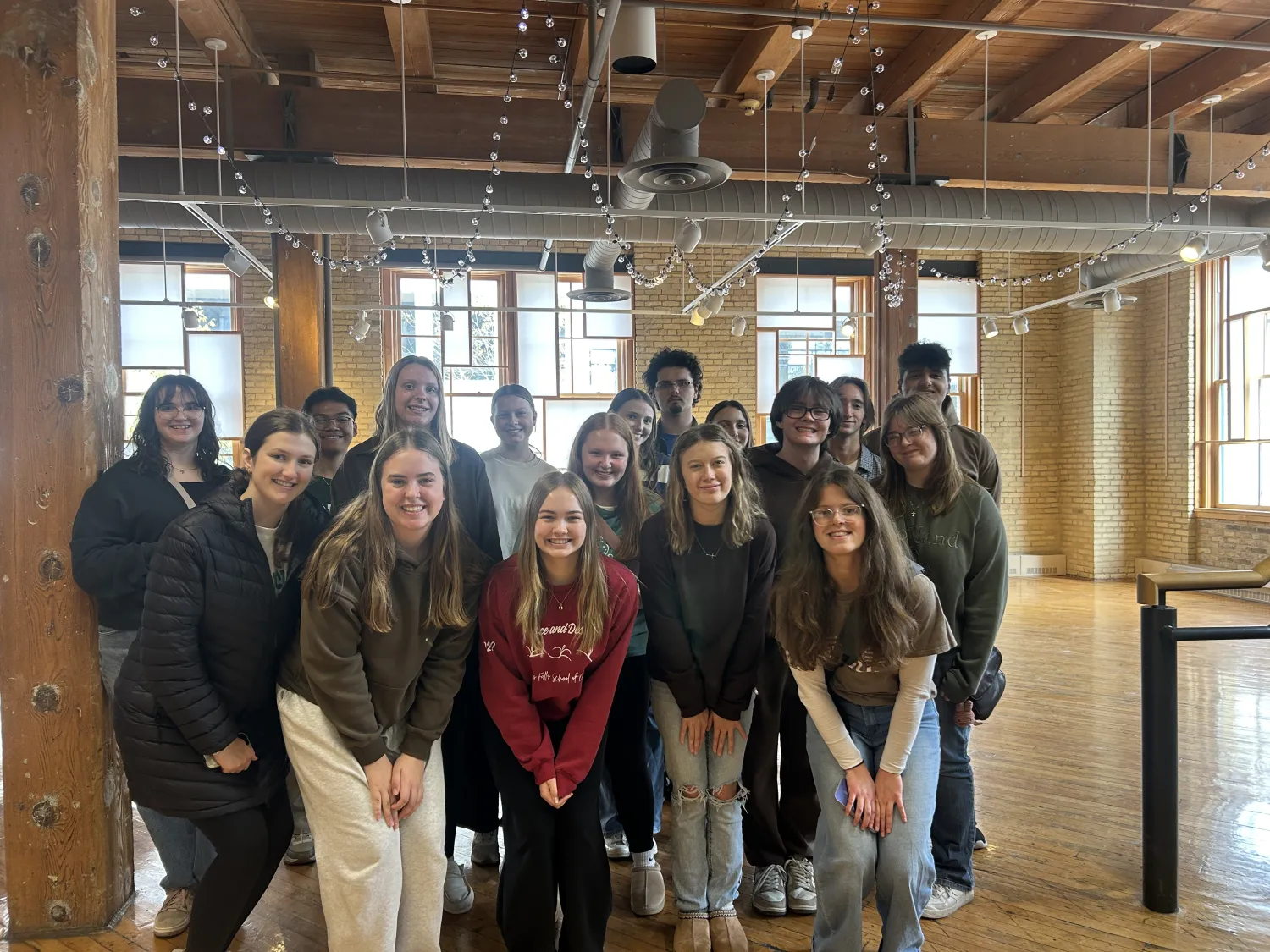A group of students stand close together to pose of a picture.