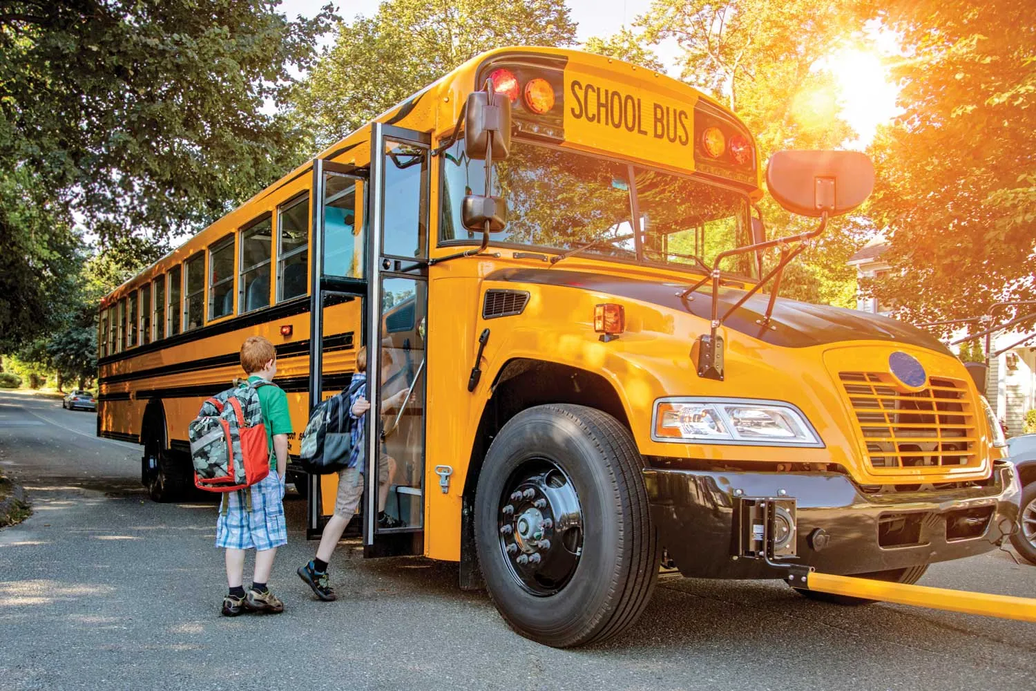 Children boarding a school bus.