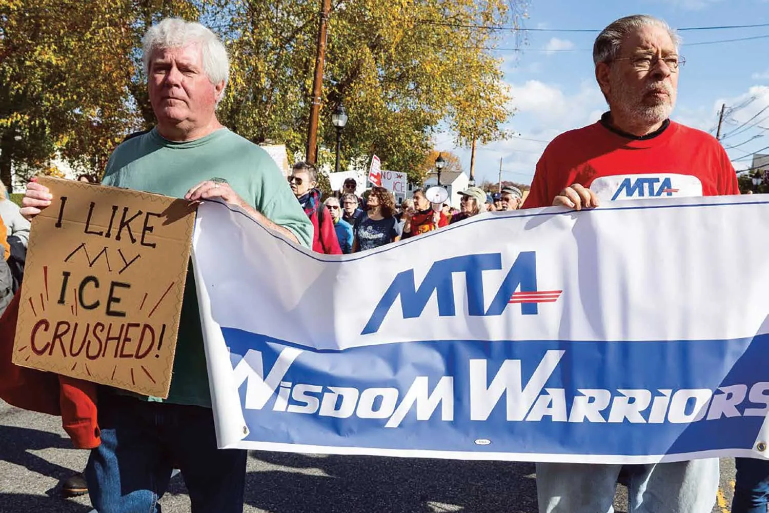 Massachusetts Retired educators Jim Murphy and Andrei Joseph protest ICE raids alongside other Wisdom Warriors.