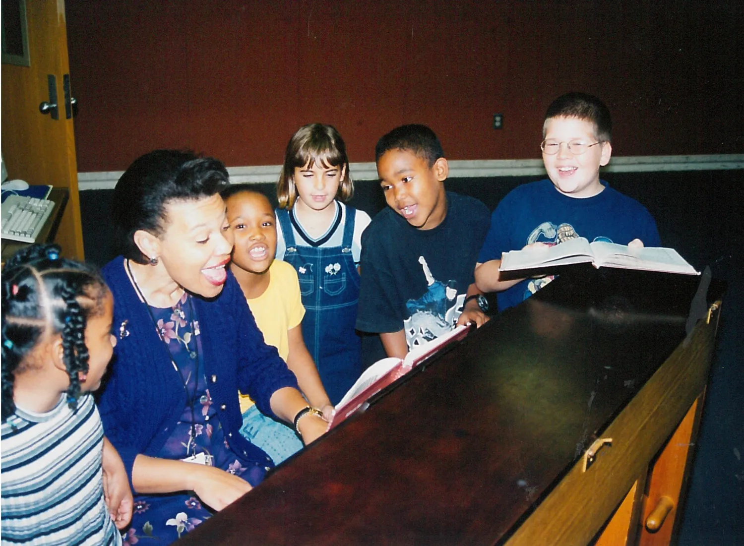 An undated photo of Princess Moss at piano with students