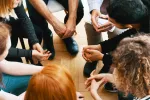 teenagers in group therapy session sitting in circle