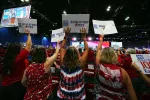 Delegates to the 2023 NEA RA hold up signs saying Education Votes