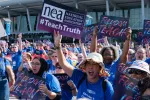 Educators hold Freedom to Teach signs at rally in Orlando