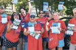 Massachusetts teachers wearing red shirts rally in support of the fair share amendment