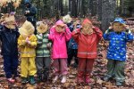 Photo of Maine pre-K students holding leafs to their faces