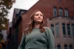 Reagan Williams stands in front a building on campus