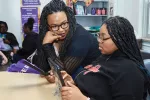 Kennita Ballard works with a student in the classroom