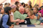 Gov. Tim Walz surrounded by students