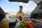 Tamara Russell unloading groceries from her car