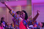 Woman with stretched out arms, expressing joy.
