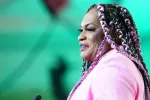 The profile of a woman in a pink jacket.