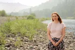 Idaho teacher Janna Privette standing on the shores of a mountain river.