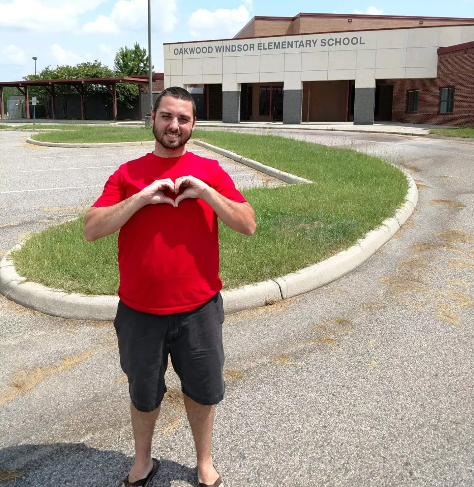 John Ross in front of his school