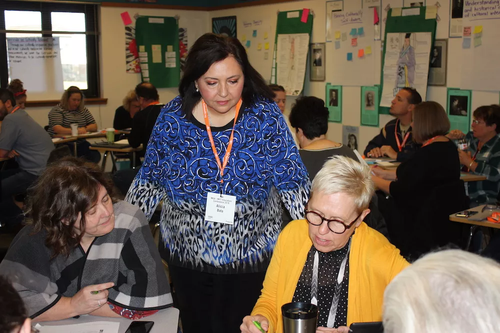 Alicia bata with teachers in classroom