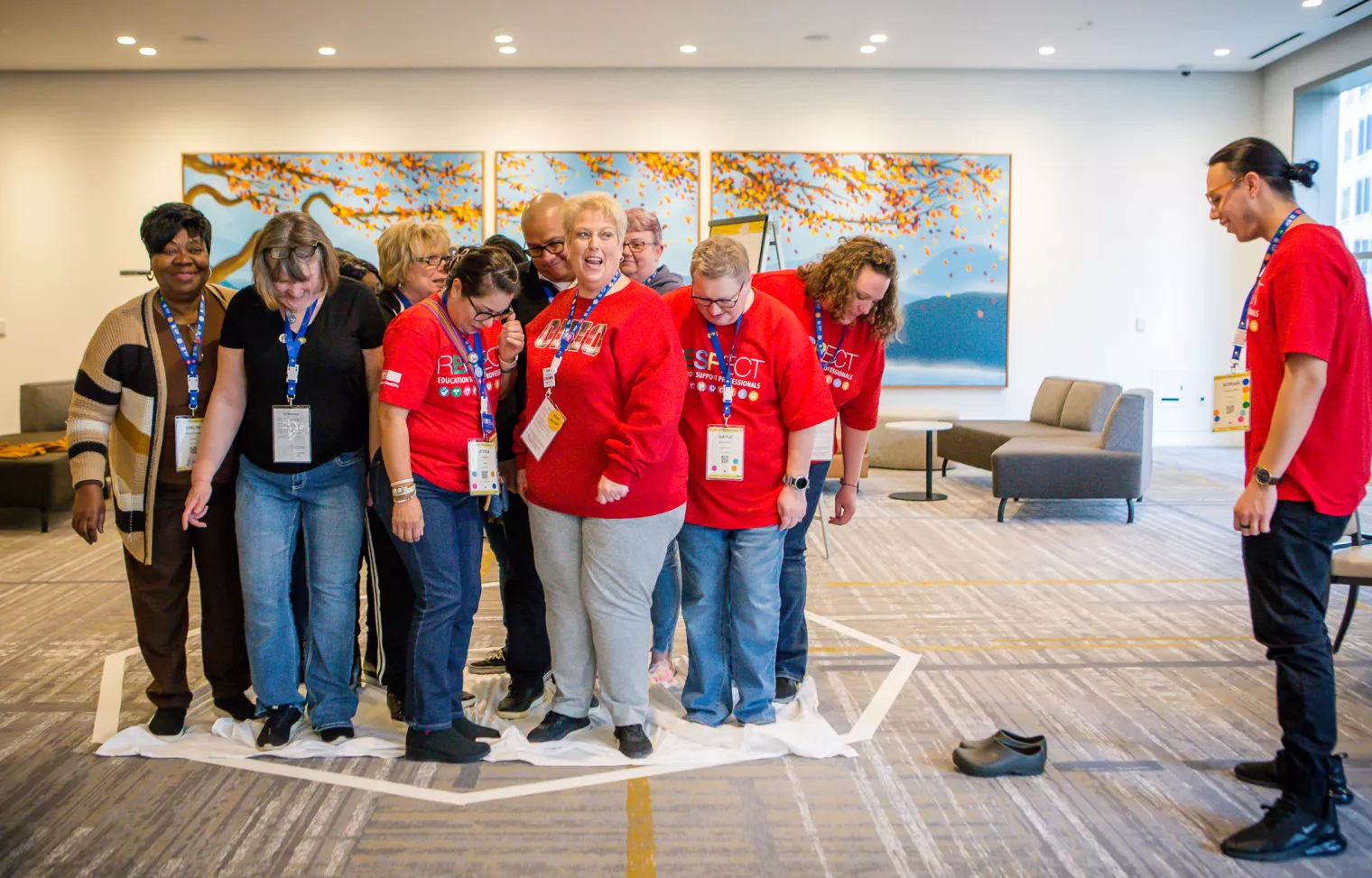 a group of educators stand in a drawn circle during an ESP Conference workshop