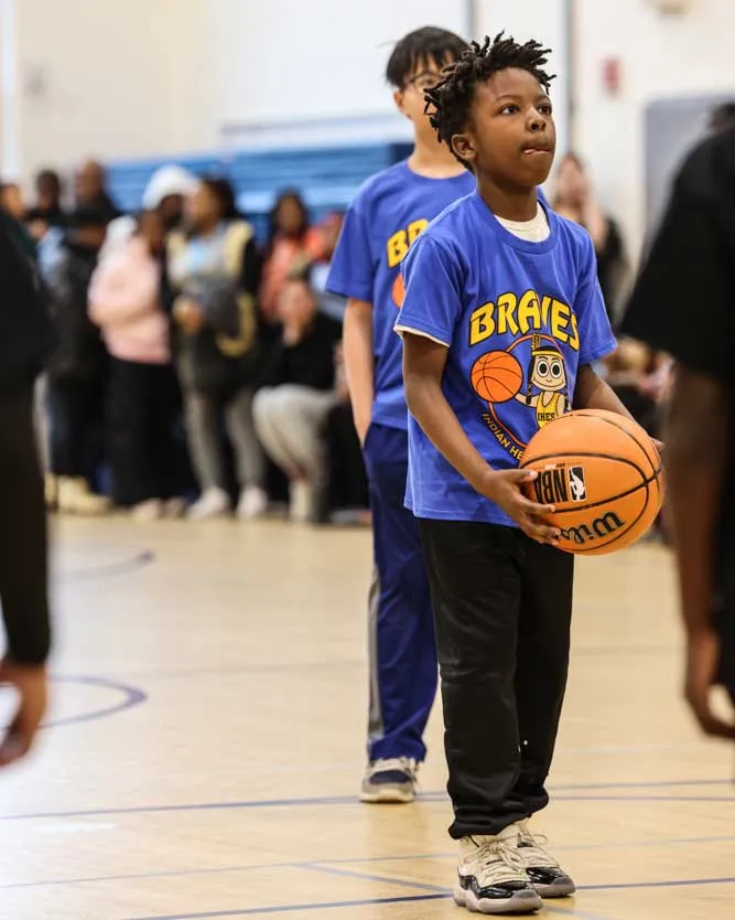 Male student concentrating before taking a foul shot.