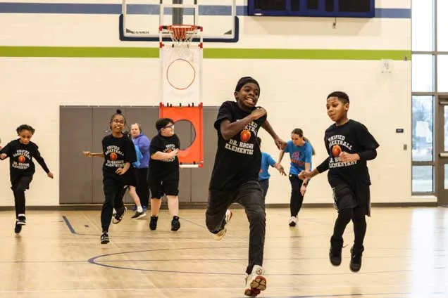 IDEA students running up and down the basketball court/