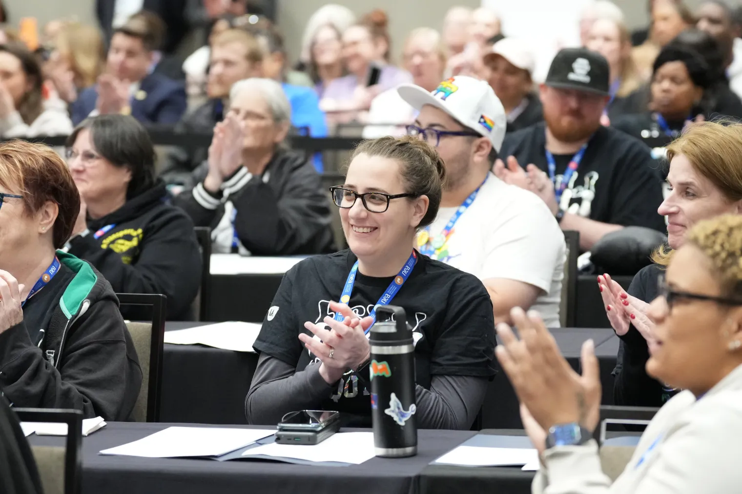 group of educators clapping in an audience