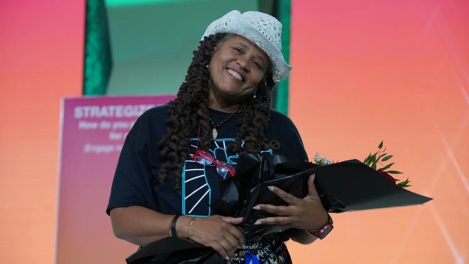 Woman in cowboy hat holding bouquet