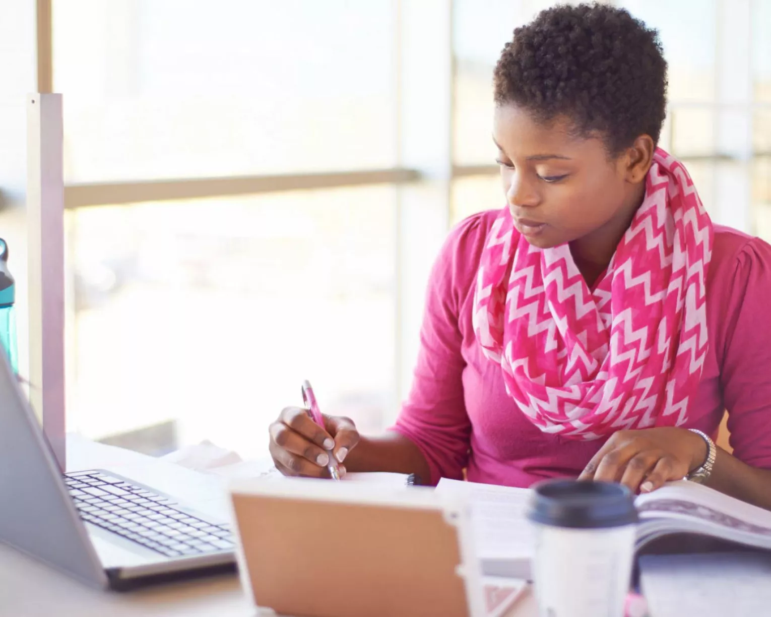 A woman studies using a laptop