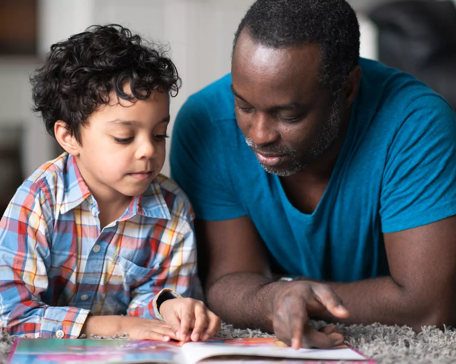 A father and son read together