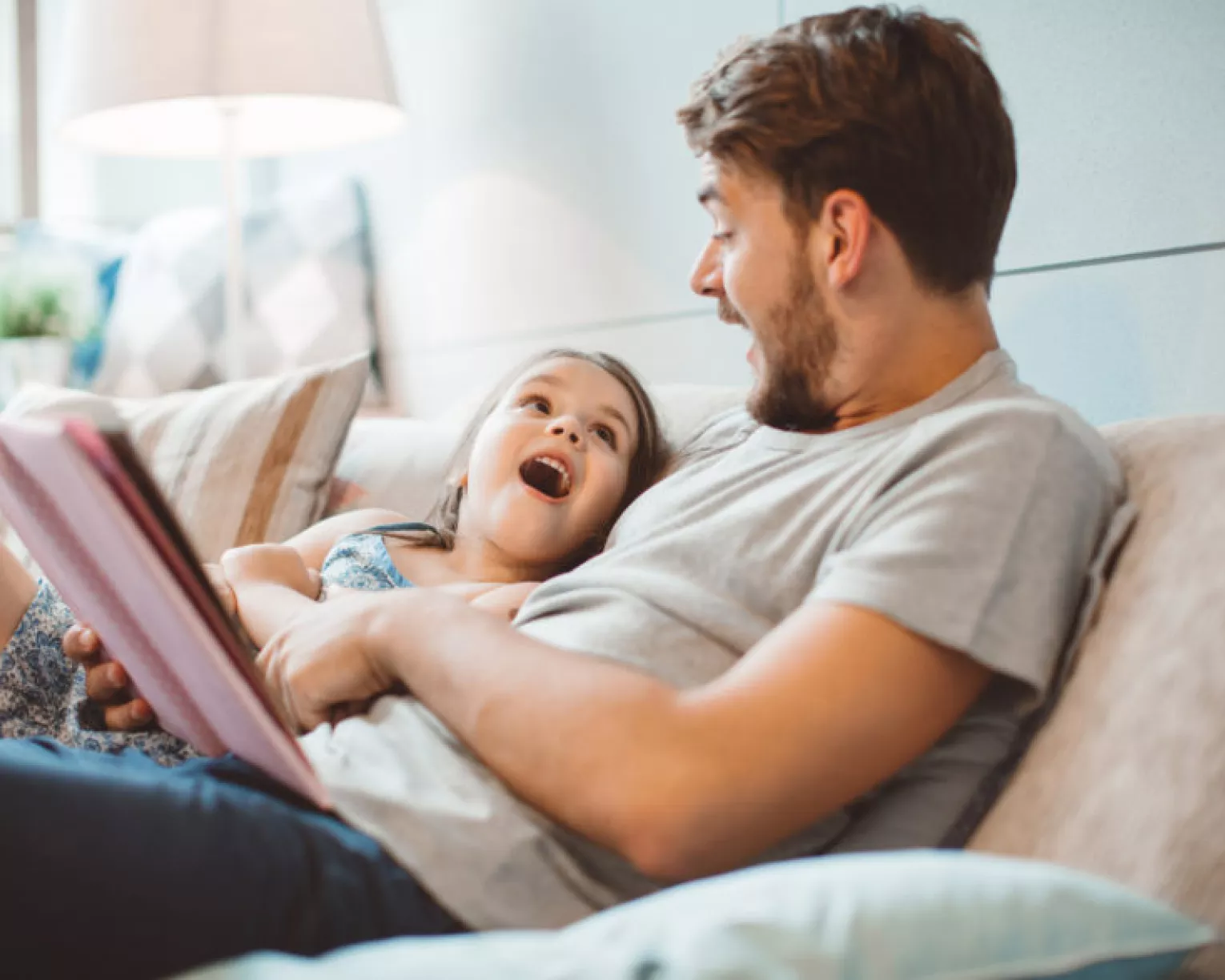 A father reads to his daughter