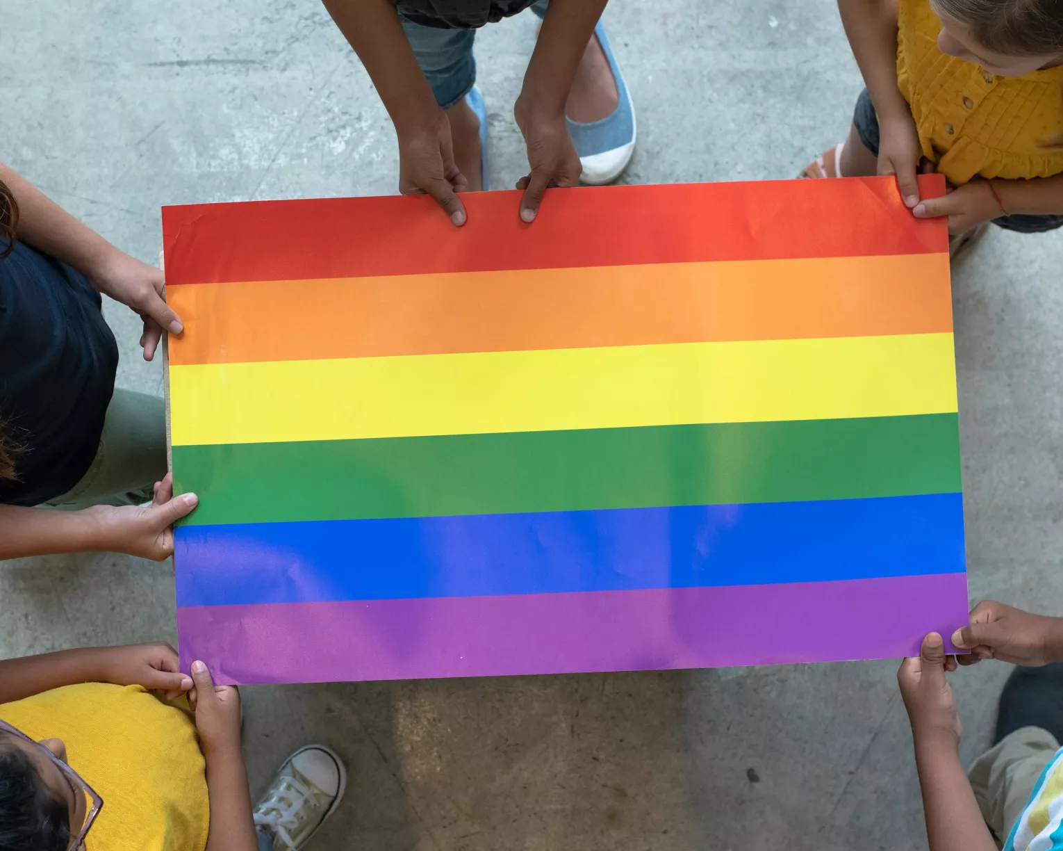 Children hold a Pride flag