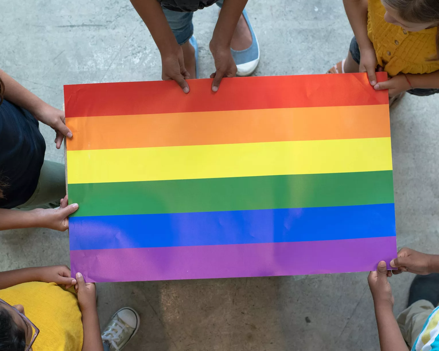 Children hold a Pride flag