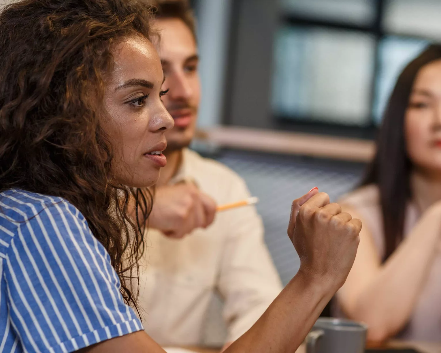 A woman speaks in a meeting