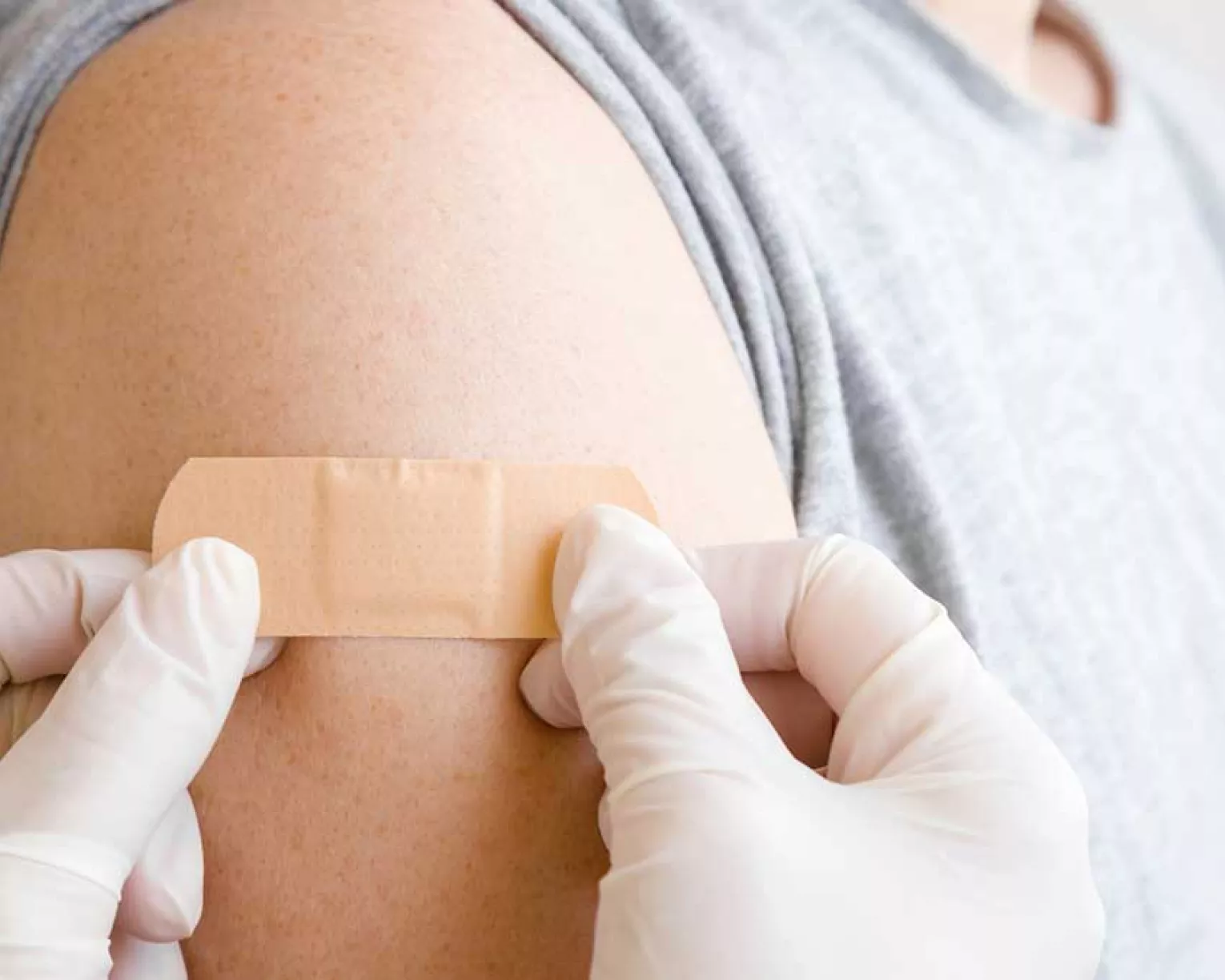Nurse applies a bandage to a child's arm