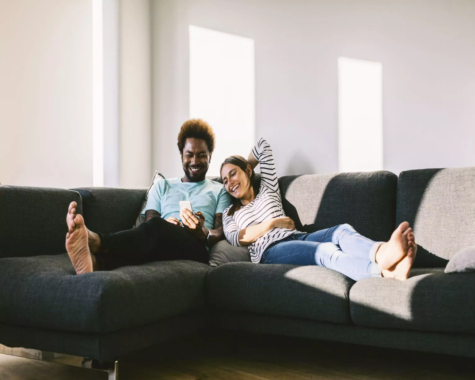 Two people sitting on sofa