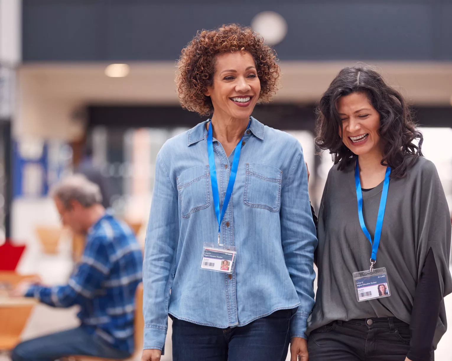 Two teachers walk through a hallway