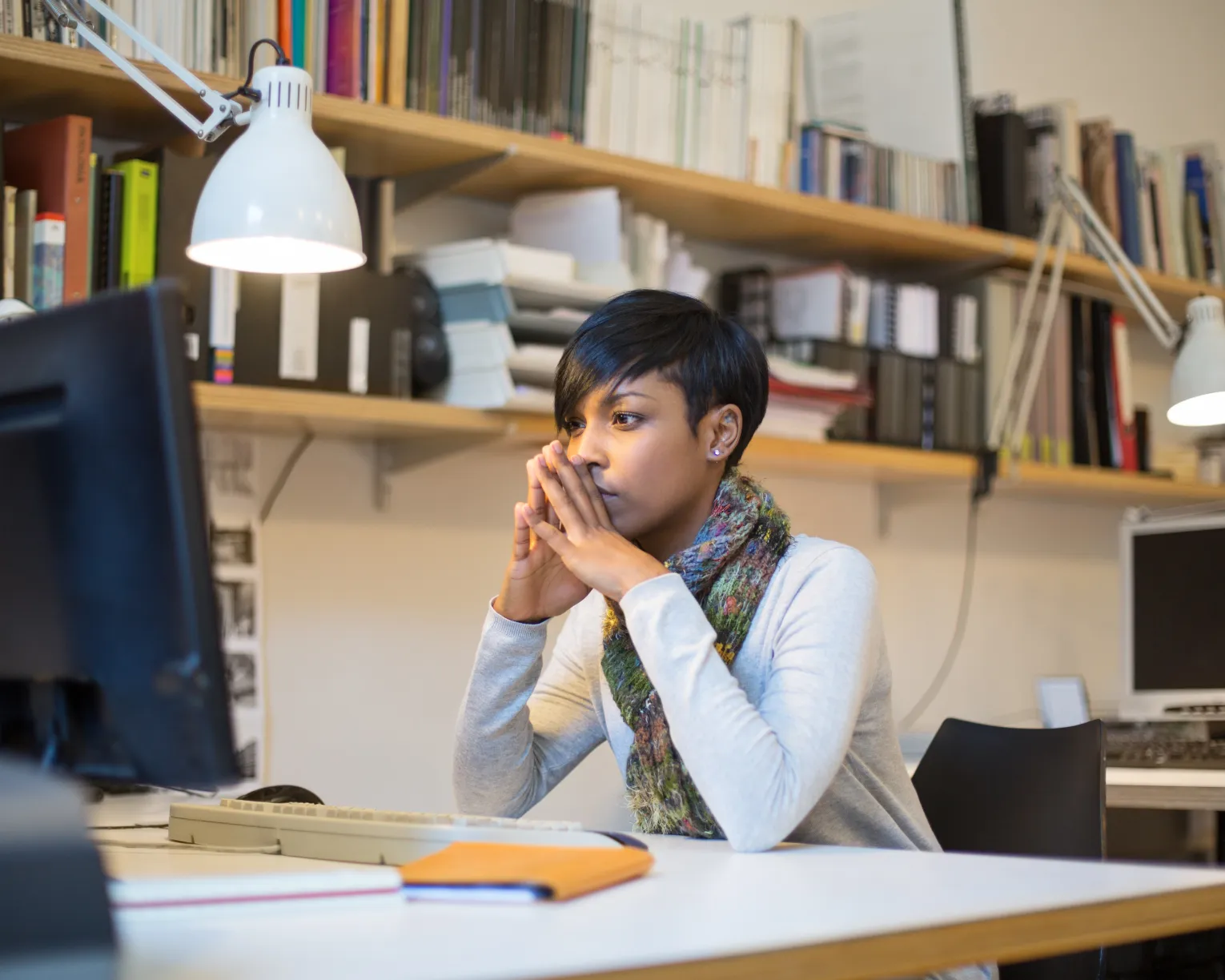 Teacher at desk using computer